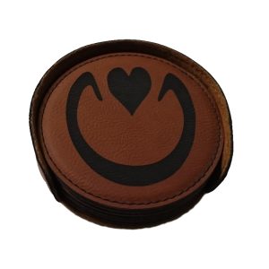 A stack of leather coasters with the Hoofbeats icon imprinted on them; the outline of a horse's hoof with a heart in the centre
