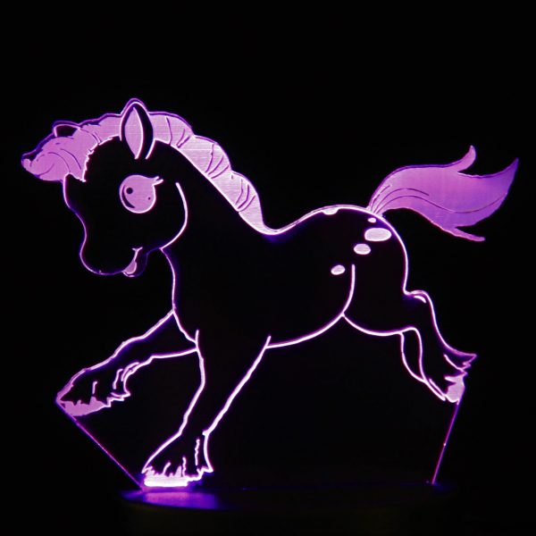A laser cut design of a cartoon pony, illuminated in pink