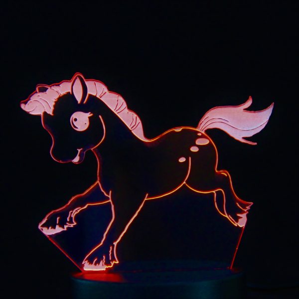 A laser cut design of a cartoon pony, illuminated in red