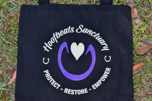 Our black coloured Hoofbeats tote bag, featuring the Hoofbeats Sanctuary logo