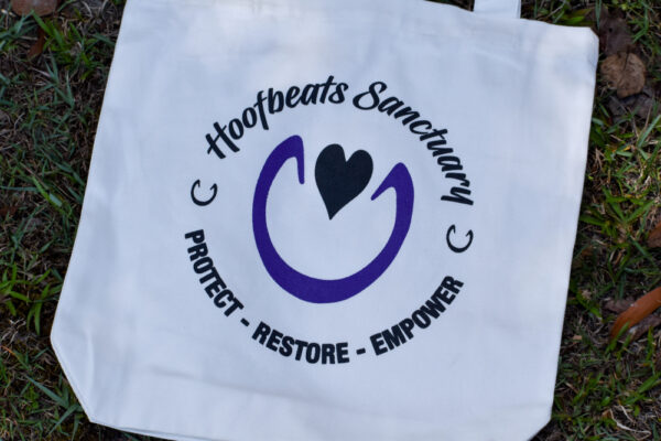 Our white coloured Hoofbeats tote bag, featuring the Hoofbeats Sanctuary logo