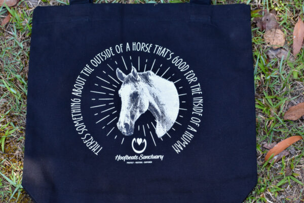 Our black coloured Hoofbeats tote bag, featuring artwork of Kazu, one of our horses