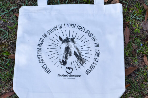 Our white coloured Hoofbeats tote bag, featuring artwork of Kazu, one of our horses